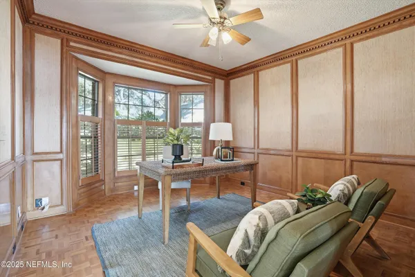 a bedroom with bed couch and window