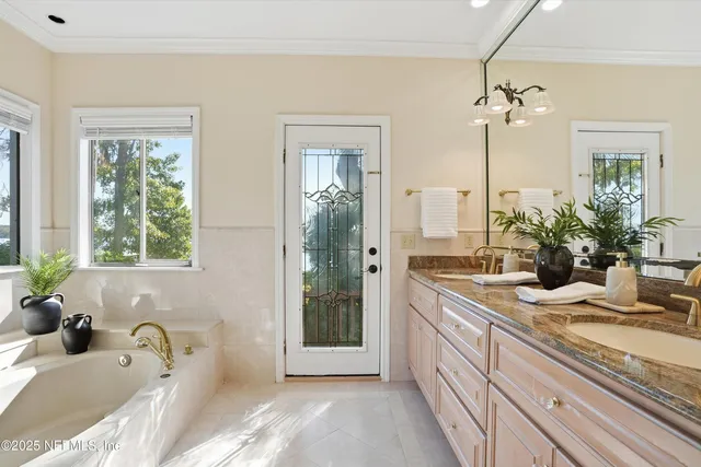 a bath tub sitting in a bathroom next to a window