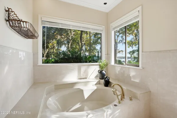a living room with furniture a wooden floor and a large window