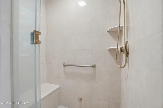 a living room with furniture a wooden floor and a large window