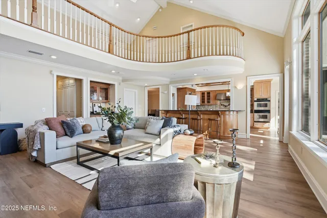 a living room with furniture a fireplace and a large window