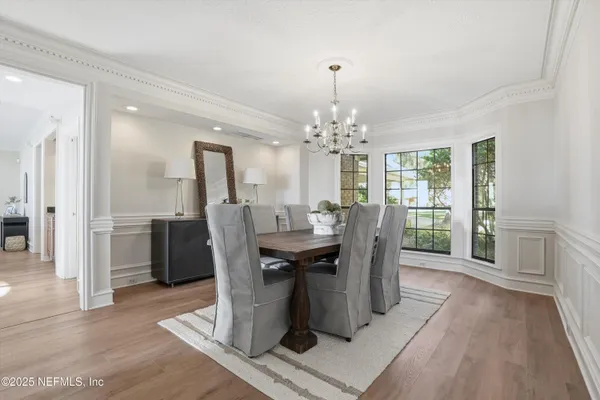 a living room with furniture a fireplace and a large window