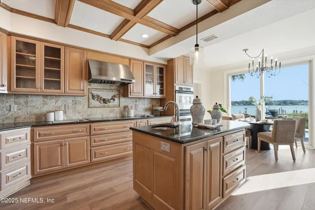 a bathroom with a granite countertop sink and a wooden floor