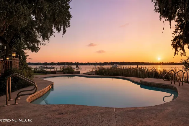 a view of a swimming pool with lake view and mountain view