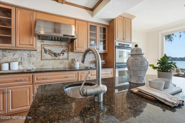 a kitchen with stainless steel appliances a refrigerator sink and cabinets
