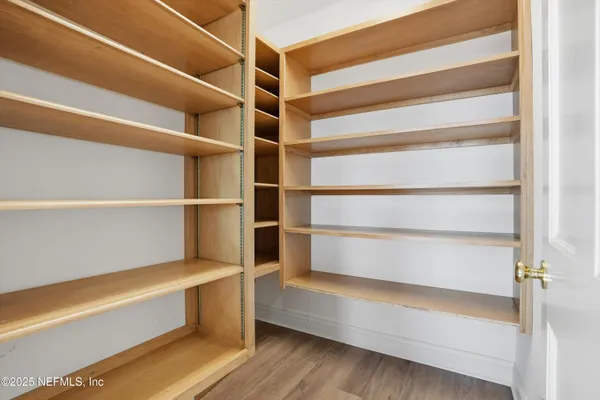 a bedroom with a bed and a chair