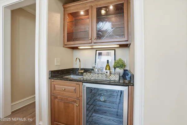 an empty room with a ceiling fan and windows