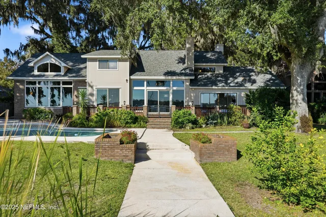 a view of house with garden space and trees