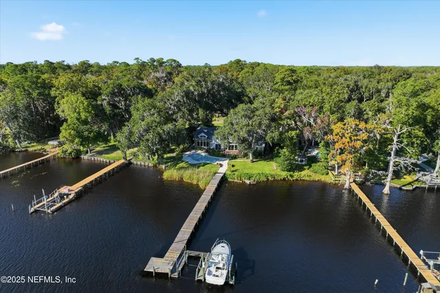 an aerial view of a house with garden space and street view