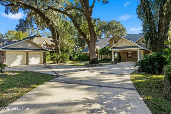 a view of a brick house with potted plants
