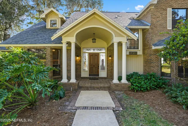 a living room with furniture windows and kitchen view