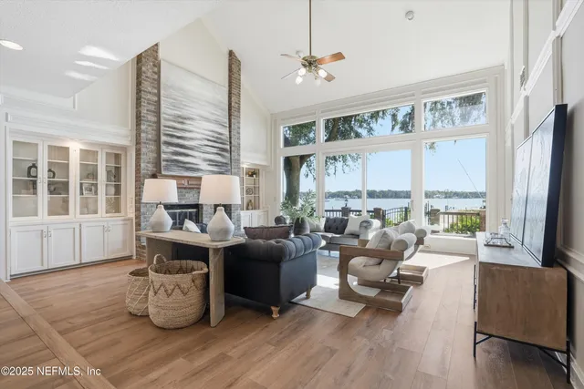 a living room with furniture a fireplace and a table