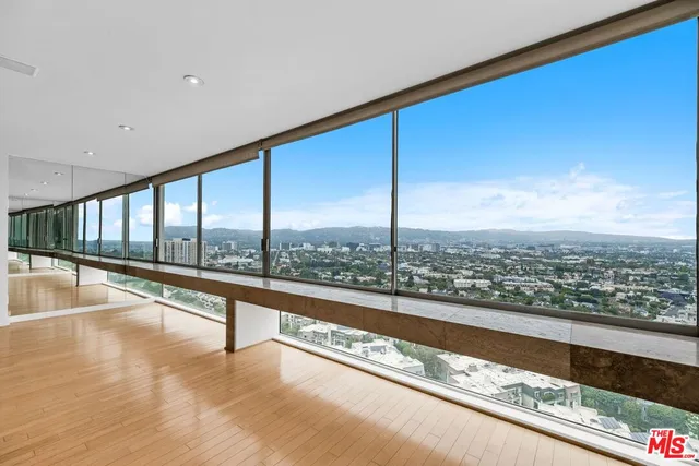 a view of an empty room with a floor to ceiling window