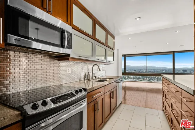 a kitchen with stainless steel appliances granite countertop a stove and a microwave