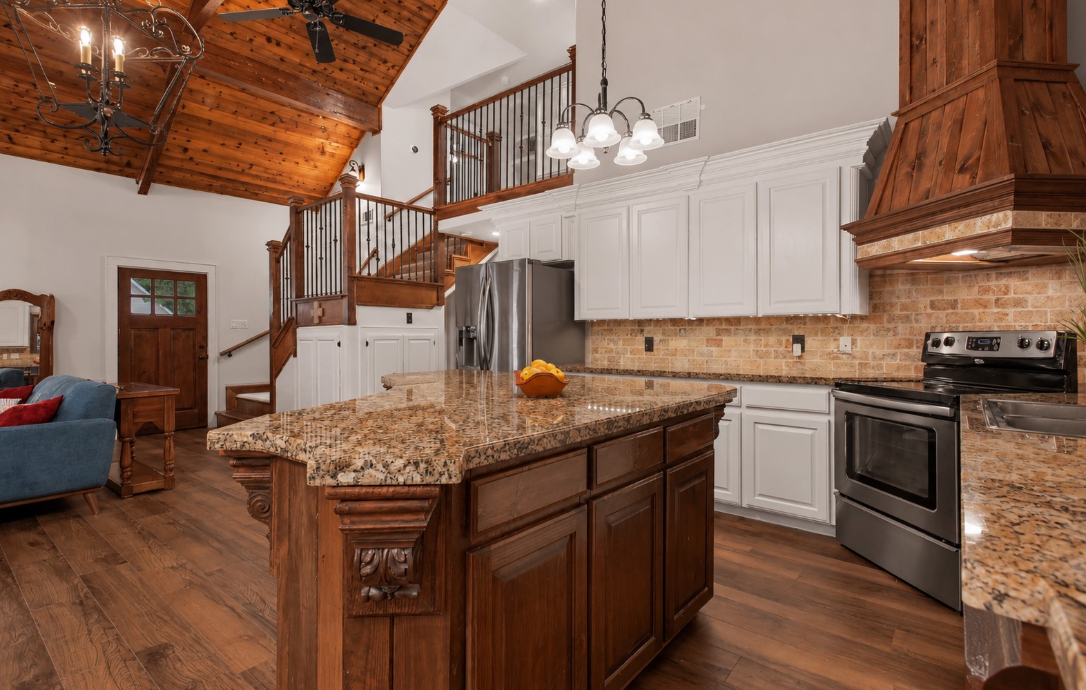 312 Springwood Drive Conroe, TX 77385 - Photo 16 of 50 Kitchen island provides additional seating and workspace for everyday living.
