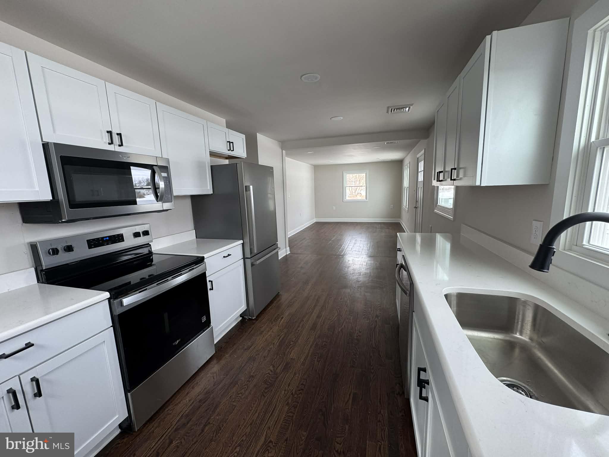 183 Knights Corner Road Elkton, MD 21921 - Photo 2 of 8 a kitchen with stainless steel appliances a stove a sink a microwave a refrigerator and cabinets