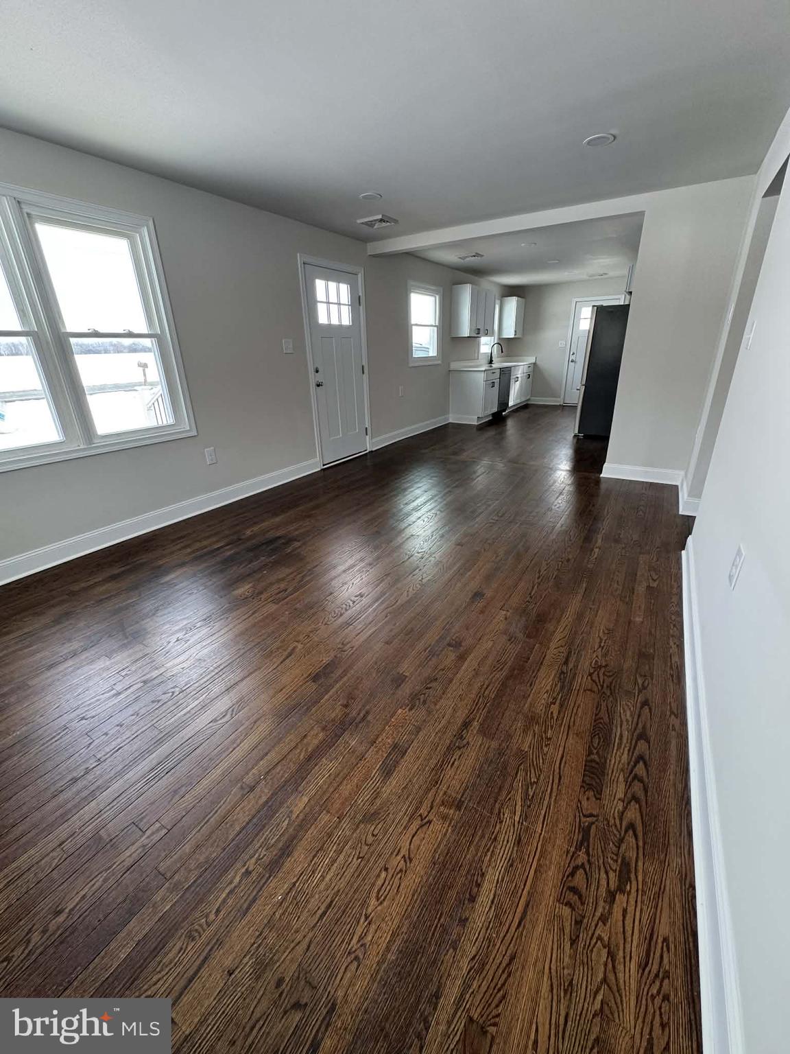 183 Knights Corner Road Elkton, MD 21921 - Photo 6 of 8 an empty room with wooden floor and windows