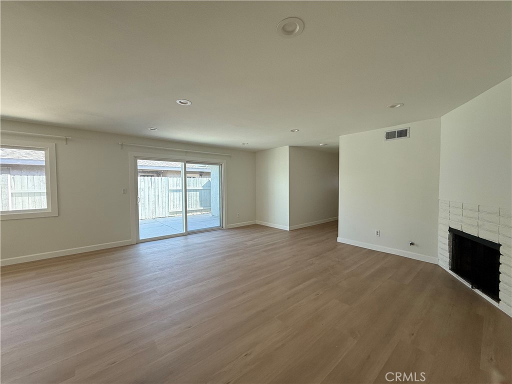 6441 St Paul Circle, Unit A Huntington Beach, CA 92647 - Photo 3 of 13 a view of an empty room with a window and fireplace