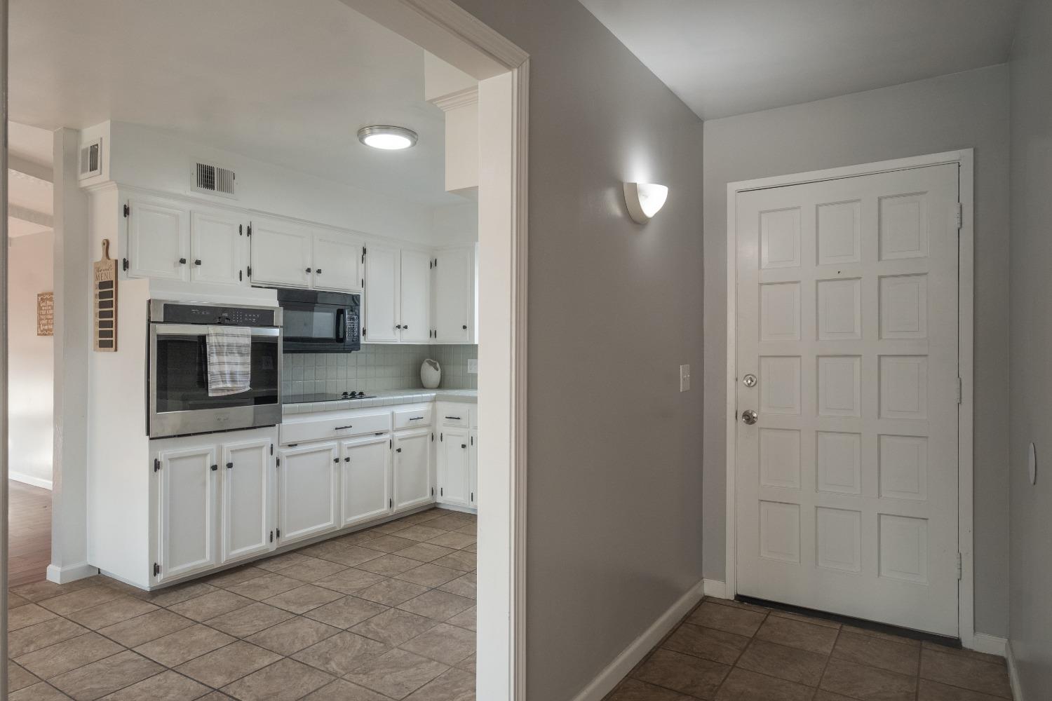 2248 Sunnyside Avenue Clovis, CA 93612 - Photo 3 of 25 a kitchen with granite countertop white cabinets and stainless steel appliances