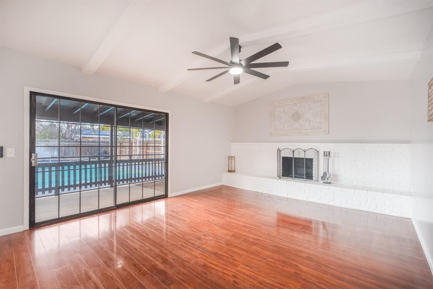 2248 Sunnyside Avenue Clovis, CA 93612 - Photo 6 of 25 a view of a livingroom with wooden floor and a ceiling fan