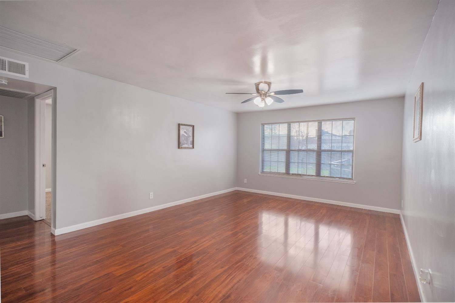 2248 Sunnyside Avenue Clovis, CA 93612 - Photo 8 of 25 a view of an empty room with wooden floor and a window