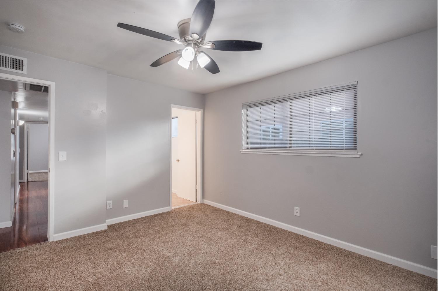 2248 Sunnyside Avenue Clovis, CA 93612 - Photo 10 of 25 an empty room with windows and fan