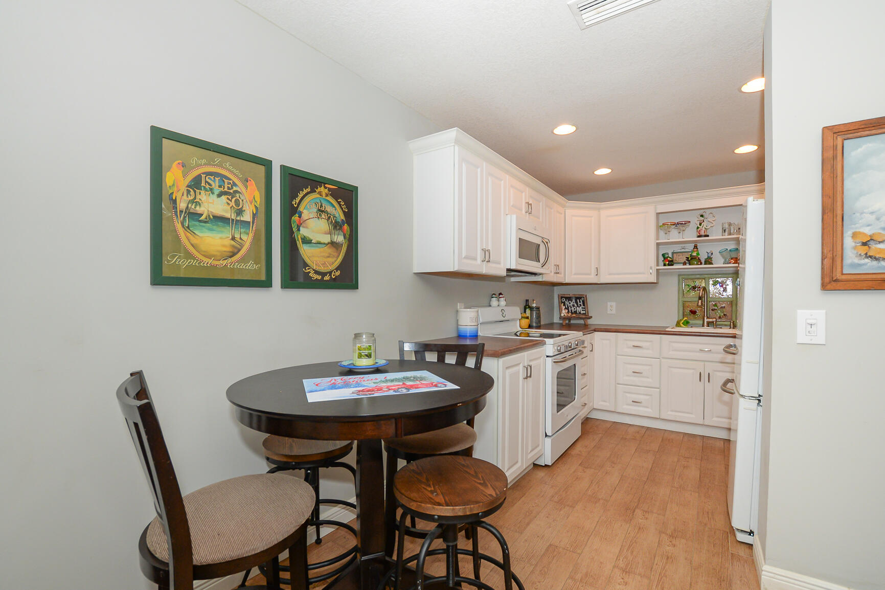 2123 Southeast Wayne Road Stuart, FL 34994 - Photo 6 of 24 a kitchen with a table chairs and wooden floor