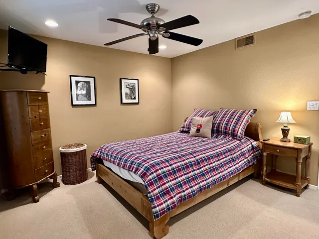 a bathroom with a sink a toilet a mirror and shower