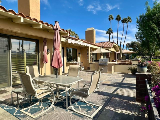 a view of a patio with table and chairs and potted plants