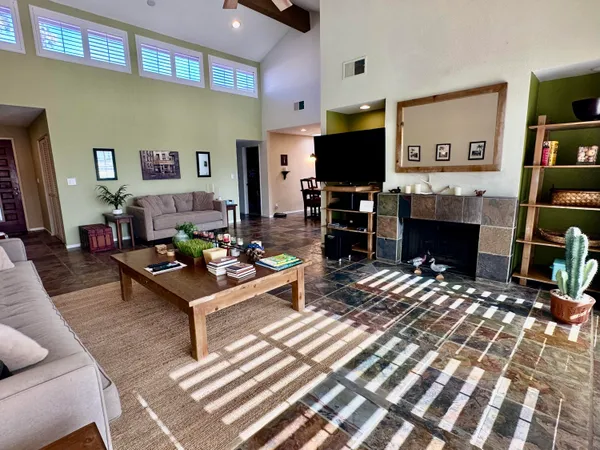 a view of a dining room with furniture and chandelier