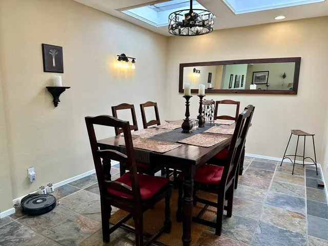 a kitchen with stainless steel appliances granite countertop a refrigerator a stove a sink and white cabinets