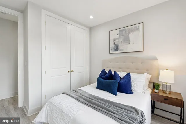 a bedroom with a bed and a painting on the wall