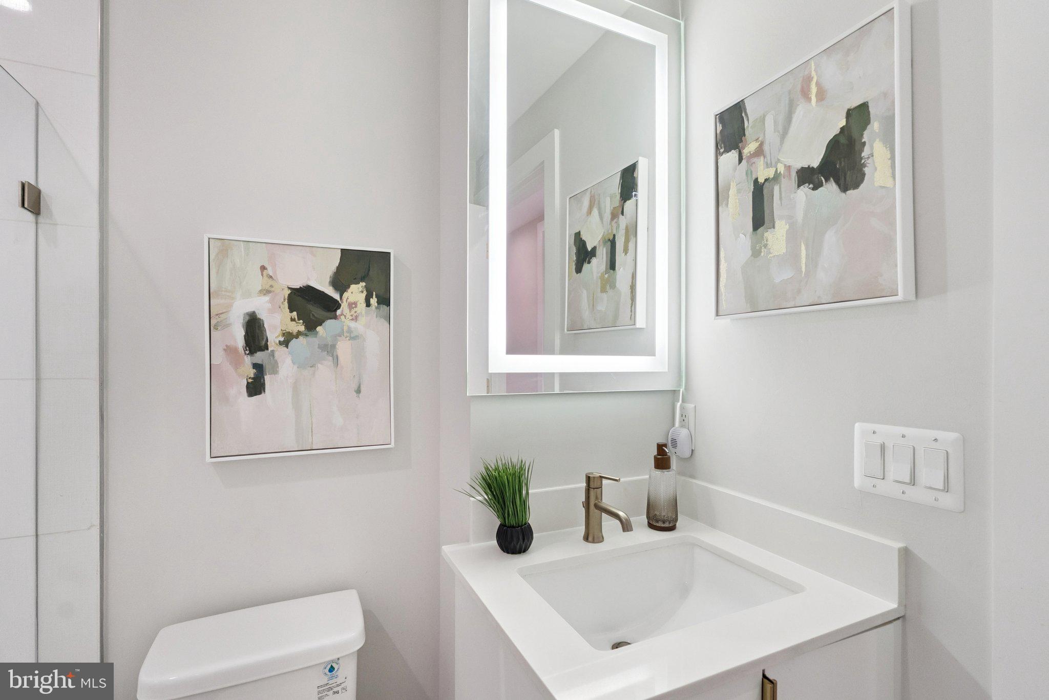 839 Kennedy Street Northwest, Unit 105 Washington, DC 20011 - Photo 13 of 21 a bathroom with a sink and a mirror