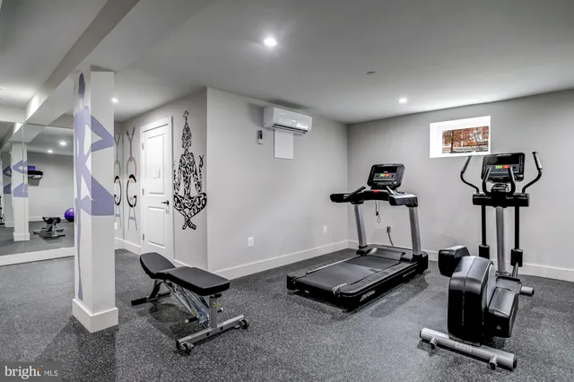 a room with gym equipment and a view of living room