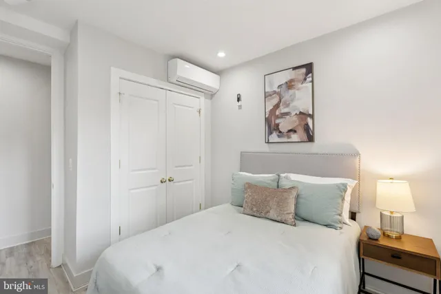 a bedroom with a bed and a night stand