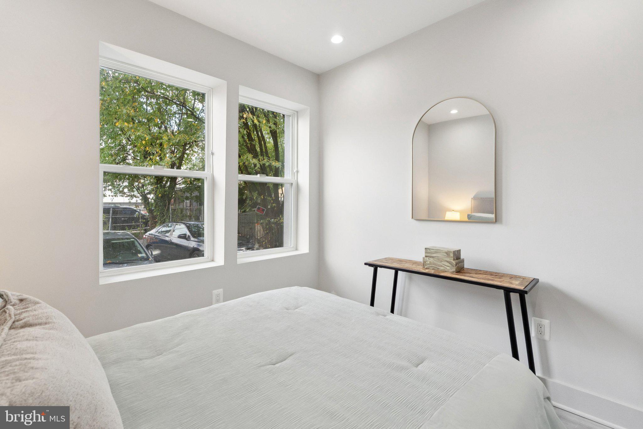 839 Kennedy Street Northwest, Unit 105 Washington, DC 20011 - Photo 9 of 21 a bedroom with a bed and a window
