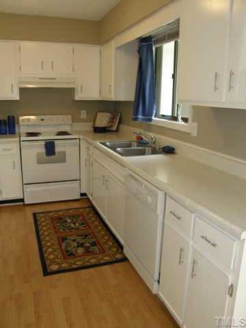 4282 Lake Ridge Drive Raleigh, NC 27604 - Photo 5 of 12 a white kitchen with sink and cabinets
