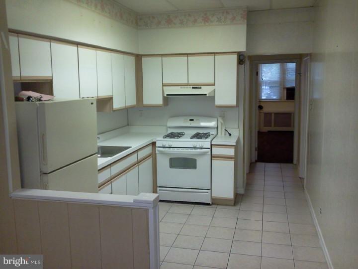 a kitchen with a stove cabinets and refrigerator