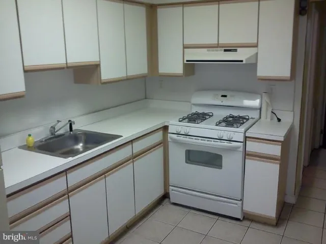 a kitchen with cabinets appliances and a sink