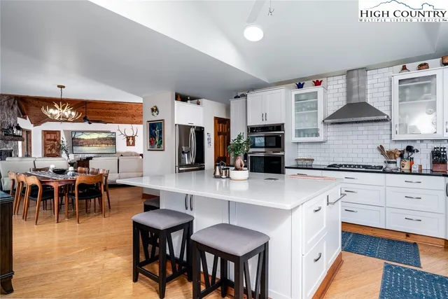 a large kitchen with stainless steel appliances lots of counter space and breakfast area