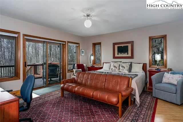 a living room with furniture ceiling fan and a rug