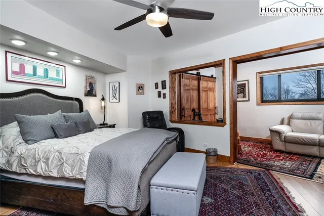 a bedroom with a bed couch and window