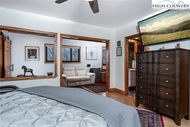 a bedroom with a bed a couch and dresser