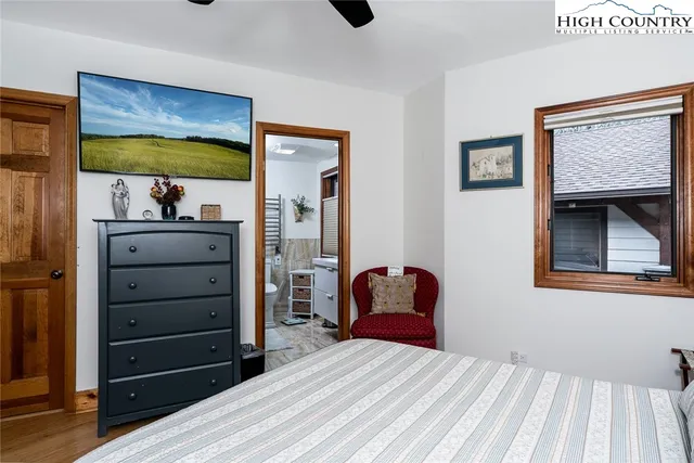 a bedroom with a bed and a mirror on dresser