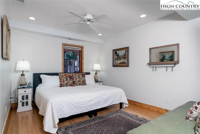 a bedroom with a large bed and a lamp