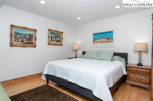 a bedroom with a bed and a lamp on table