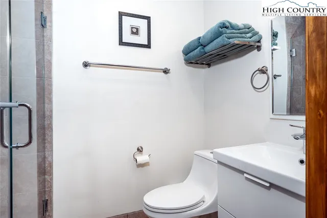 a bathroom with a toilet and a shower
