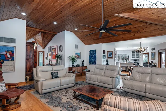 a living room with furniture a ceiling fan and a rug