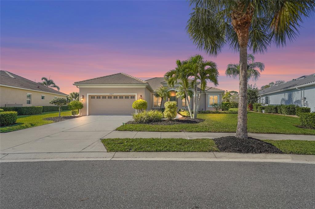 357 Marsh Creek Road Venice, FL 34292 - Photo 2 of 70 a front view of a house with a garden and a yard