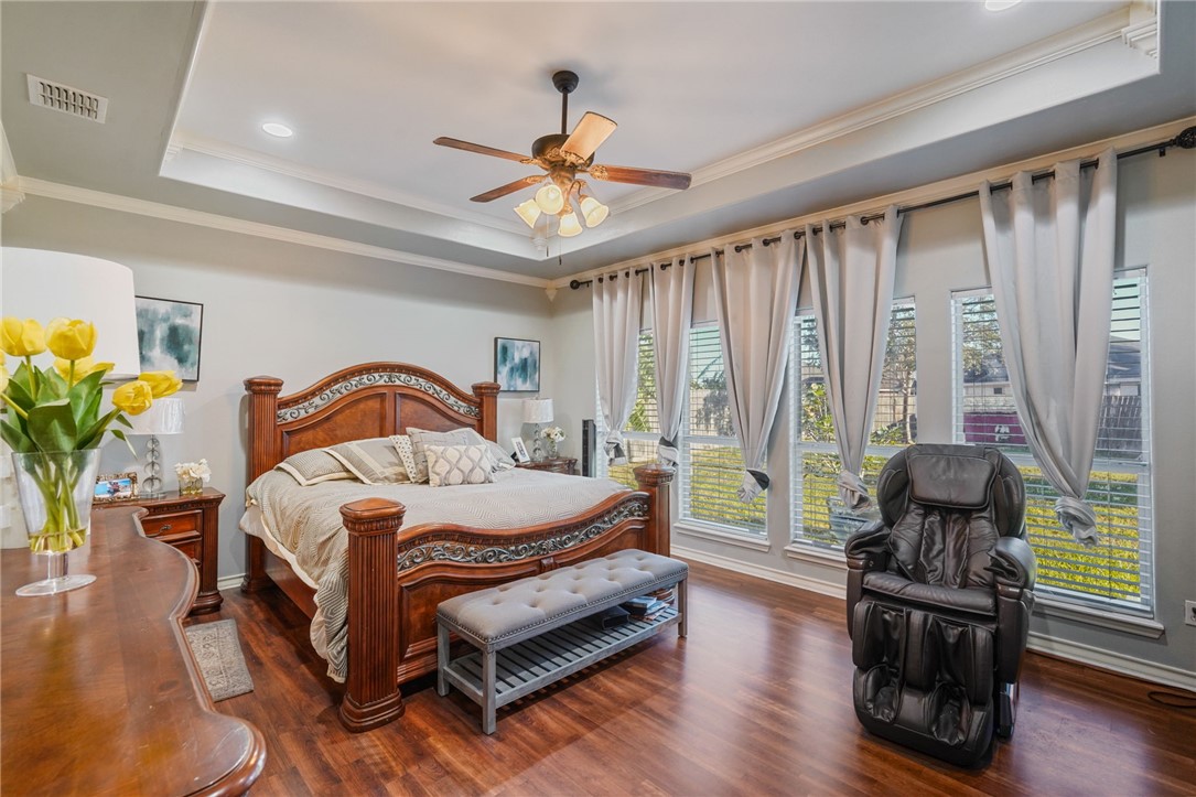 8226 Azimuth Court Corpus Christi, TX 78414 - Photo 12 of 32 a bedroom with a bed wooden floor and window